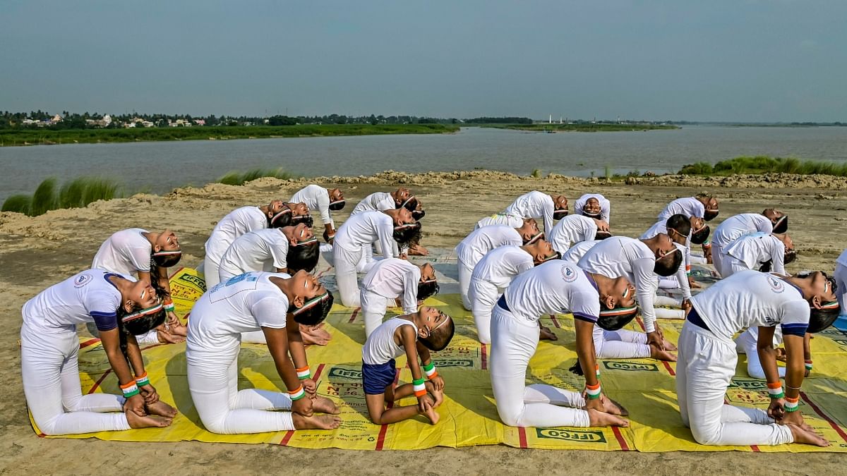 Students perform 'yoga asanas' on the bank of Hooghly river to celebrate the 8th International Day of Yoga, at Santipur in Nadia, West Bengal. Credit: PTI Photo