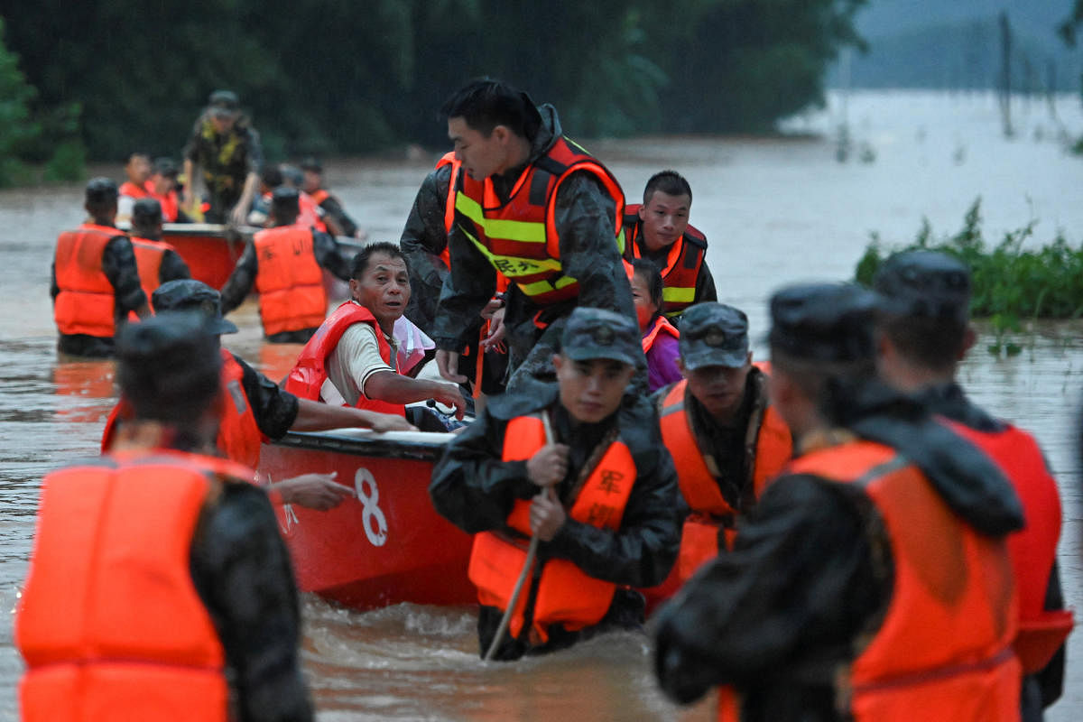 Rescue workers evacuate flood-affected residents from Xinli village with dinghies following heavy rainfall in Shaoguan, Guangdong province, China. Credit: Reuters Photo