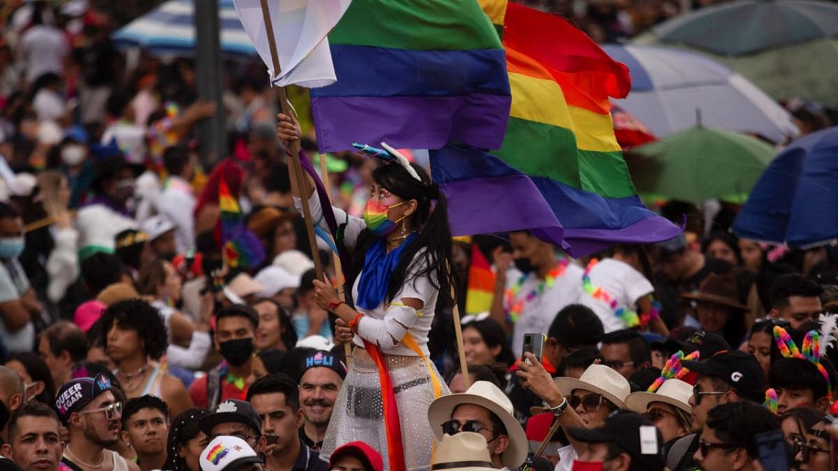 A woman holds a flag as she attends the LGBTQ+ Pride Parade after being cancelled for two years due to the Covid-19 pandemic in Mexico City. Credit: Reuters photo