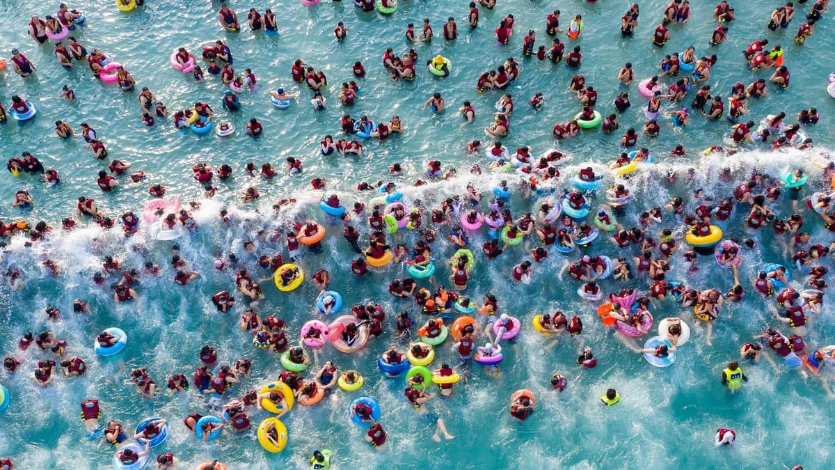 This aerial photo taken on June 25, 2022 shows people in a pool at a water park in Zhengzhou in China's central Henan province. Credit: AFP Photo