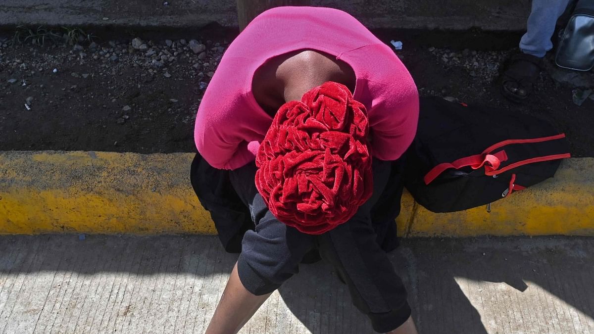 A migrant heading to the US rests after entering from Nicaragua, in Trojes, Honduras. Credit: AFP Photo