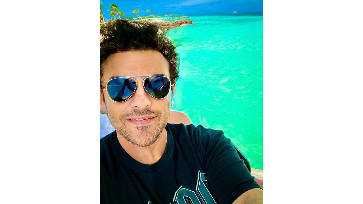 In one of the selfies, Adnan is seen flaunting a big smile with a picturesque view of the ocean and the sky in the background. Credit: Instagram/adnansamiworld