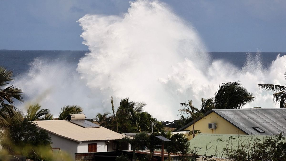 A picture shows high waves near residential houses during a breaking swell in Saint-Leu, in the south of the French island of Reunion, Indian Ocean. Credit: AFP Photo