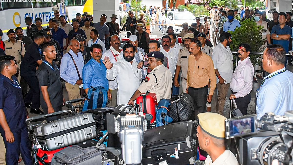 Rebel Shiv Sena leader Eknath Shinde and the supporting MLAs are seen at Guwahati International Airport. After delaying their departure by around two hours, the dissident MLAs left for Goa. Credit: PTI Photo