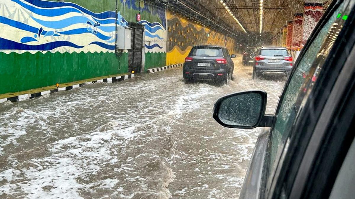 Delhi and the national capital region (NCR) reported a good spell of rain, bringing the mercury down but also leading to water logging in several places, causing inconvenience to the people. Credit: PTI Photo