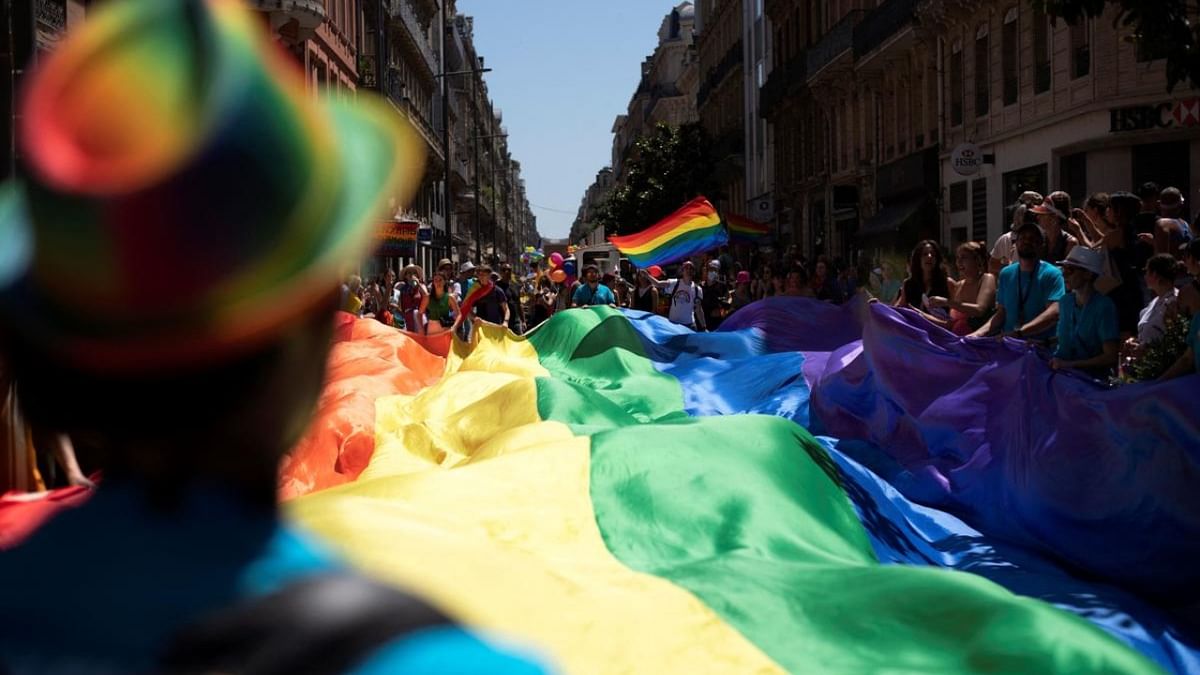 A member of the Lesbian, Gay, Bisexual and Transgender (LGBT+) community deploy a giant rainbow flag during the annual Pride Parade in Toulouse, southwestern France, on July 2, 2022. Credit: AFP Photo