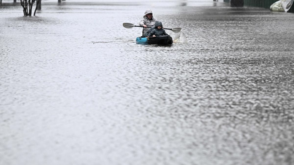 People kayak along a flooded street from the overflowing Hawkesbury river due to torrential rain in the Windsor suburb of Sydney on July 4, 2022. Credit: AFP Photo