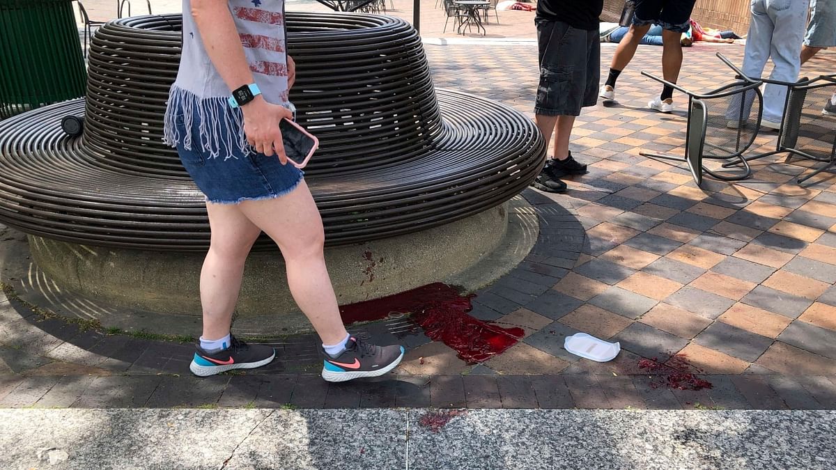 The shooting occurred at a spot on the parade route where many residents had staked out prime viewing points early in the day for the annual celebration. Dozens of fired bullets sent hundreds of parade-goers — some visibly bloodied — fleeing. Credit: AP Photo