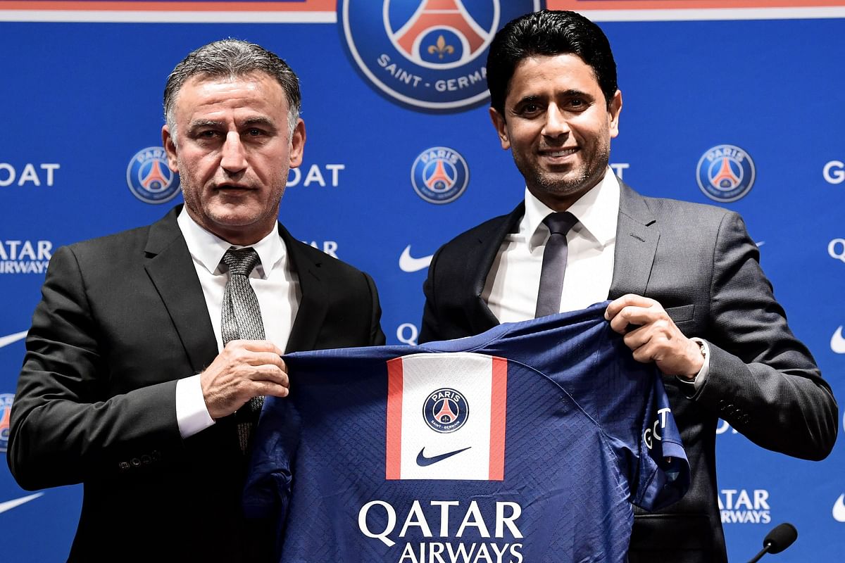 French coach Christophe Galtier (L) and PSG's President Nasser Al-Khelaifi (R) holds a jersey as they pose at the end of a press conference after Galtier was appointed as French L1 football club Paris Saint-Germain's (PSG) head coach, at the Parc des Princes stadium in Paris. Credit: AFP Photo