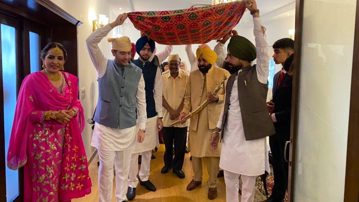 Punjab CM Bhagwant Mann was seen in a golden attire donning a yellow turban during his wedding ceremony. Credit: Twitter/raghav_chadha