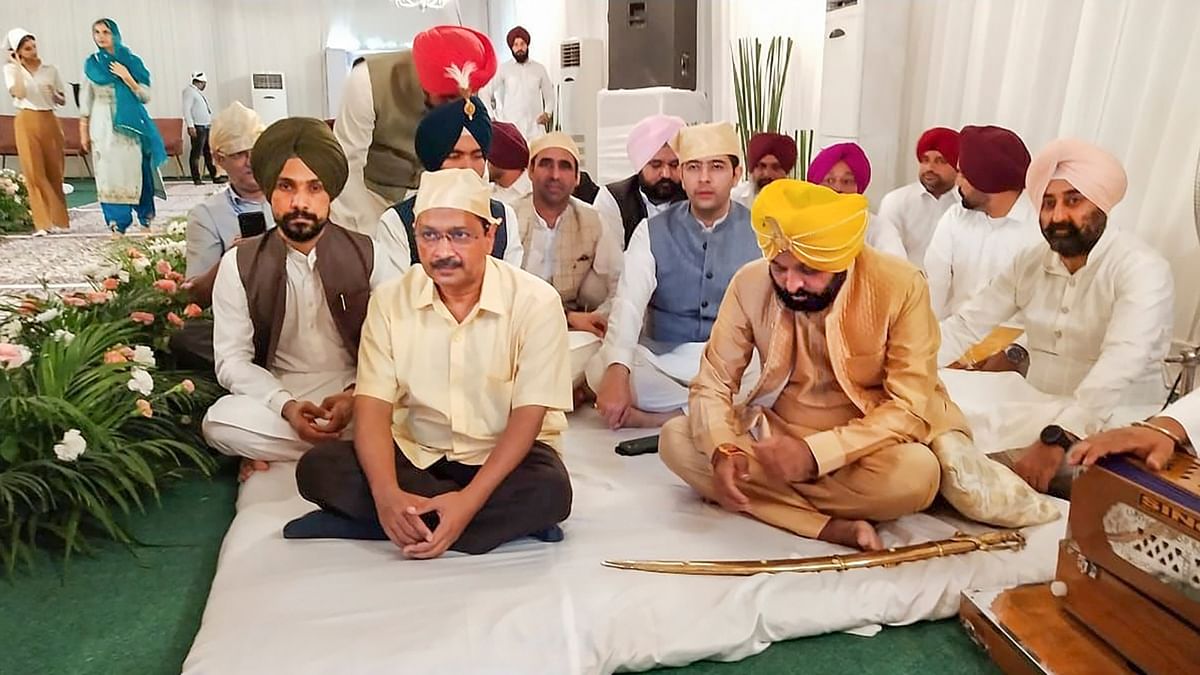 Aam Aadmi Party convenor and Delhi Chief Minister Arvind Kejriwal and Raghav Chadha were among those who graced Bhagwant Mann's wedding. Credit: PTI Photo