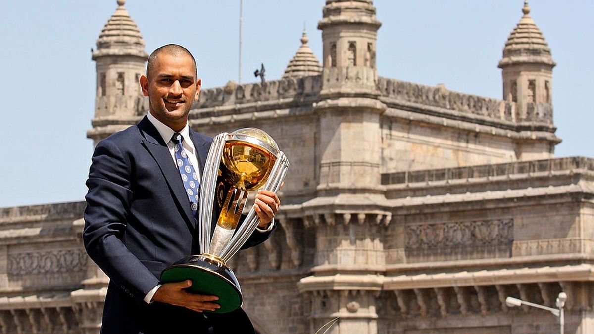 Mahendra Singh Dhoni poses with the ICC Cricket World Cup Trophy during a photo call. Credit: Getty Images
