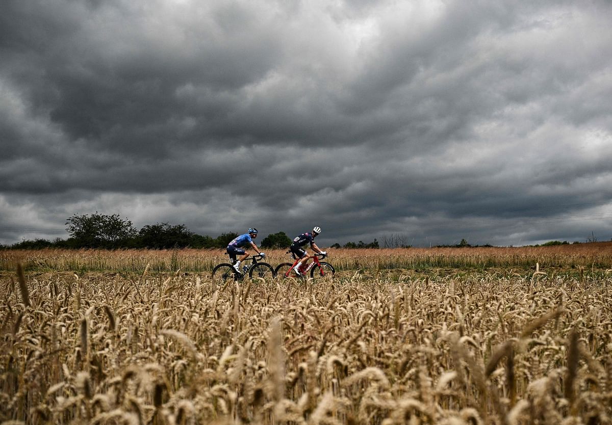 Israel-Premier Tech team's Danish rider Jakob Fuglsang (L) and Trek-Segafredo team's American rider Quinn Simons (R) cycle in a breakaway during the 6th stage of the 109th edition of the Tour de France cycling race, 219,9 km between Binche in Belgium and Longwy in northern France. Credit: AFP Photo