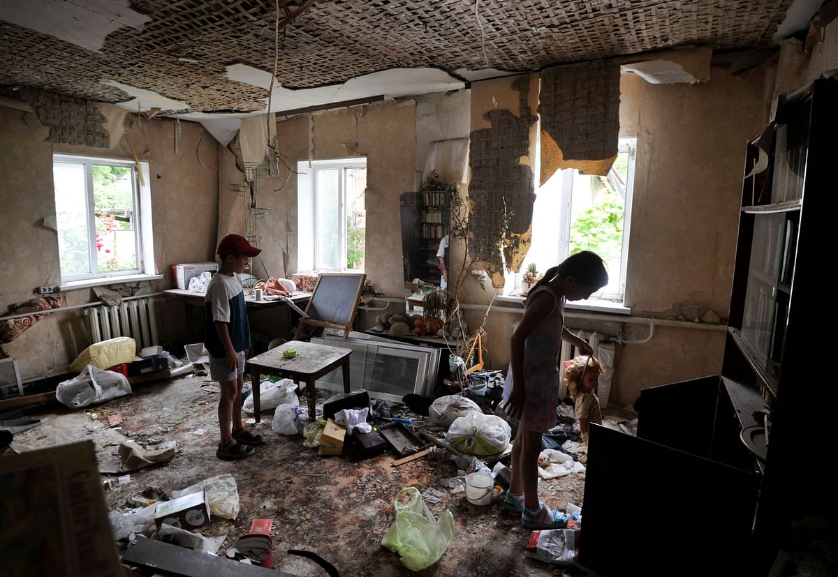 Children inspect a room damaged by the shelling in the town of Borodianka, near Kyiv. Credit: AFP Photo