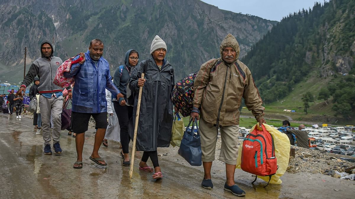 Pilgrims return to their base camp a day after the cloudburst, at Baltal in Ganderbal district of Central Kashmir. Credit: PTI Photo