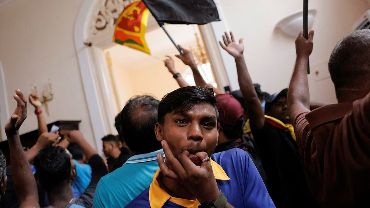 Demonstrators celebrate after entering the President's House during a protest in Colombo, Sri Lanka. Credit: Reuters Photo