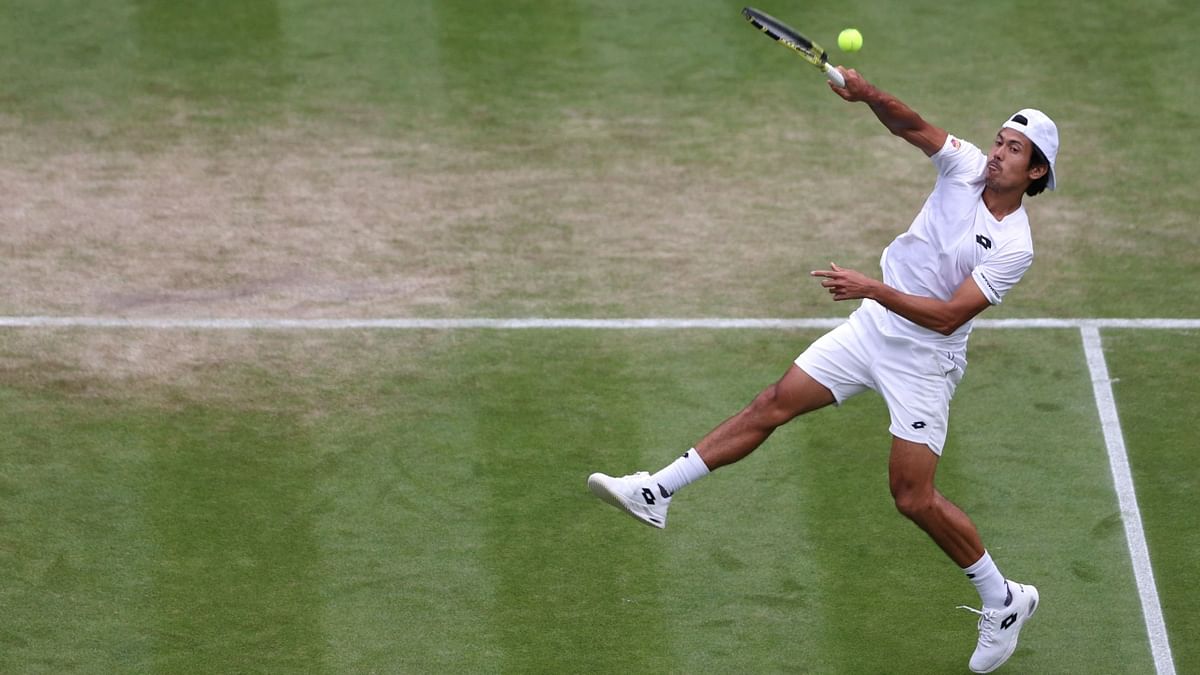 Australia's Jason Kubier returns the ball to US player Taylor Fritz during their round of 16 men's singles tennis match on the eighth day of the 2022 Wimbledon Championships at The All England Tennis Club in Wimbledon, London. Credit: AFP Photo