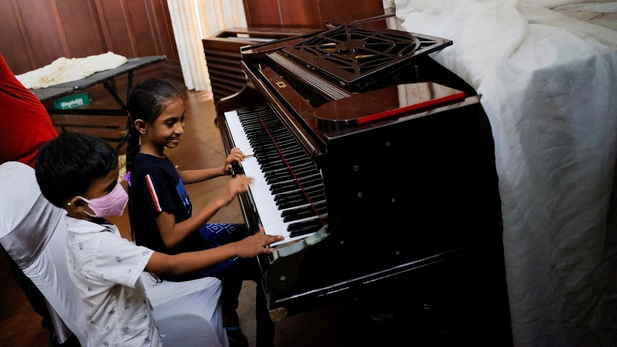 Two kids play the piano inside the President's house on the following day after demonstrators entered the building, after President Gotabaya Rajapaksa fled, amid the country's economic crisis, in Colombo, Sri Lanka. Credit: Reuters Photo