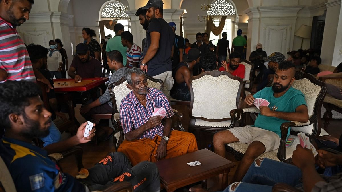 People play cards inside the official residence of Sri Lanka's Prime Minister, in Colombo. Credit: AFP Photo