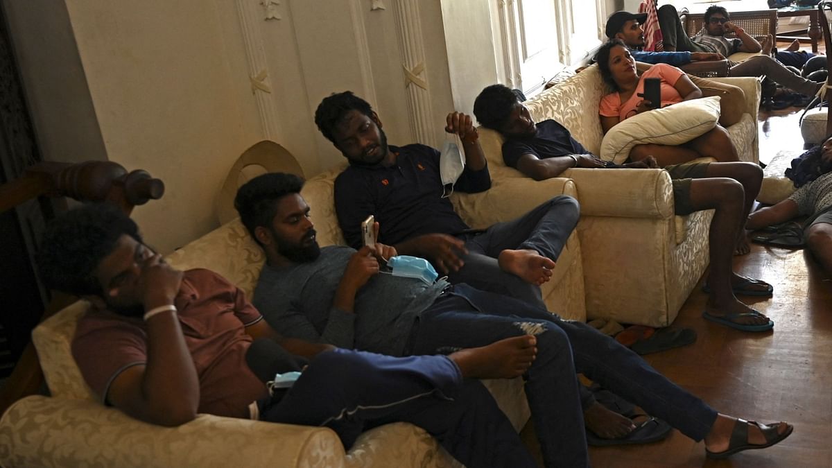 People rest inside the official residence of Sri Lanka's Prime Minister, in Colombo. Credit: AFP Photo