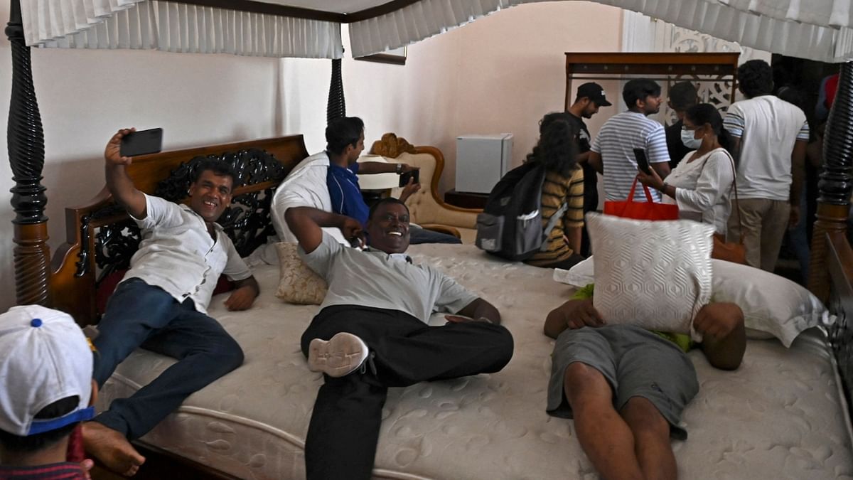 Demonstrators are seen sleeping in a bedroom at the President's house in Sri Lanka. Credit: AFP Photo