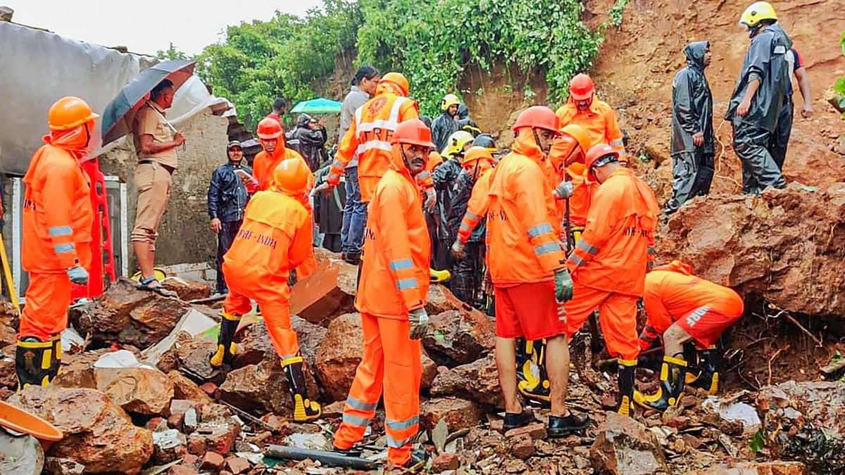 Mumbai: NDRF and fire services personnel carry out rescue and relief work following a landslide triggered by heavy monsoon rains, in Vasai. Credit: PTI Photo