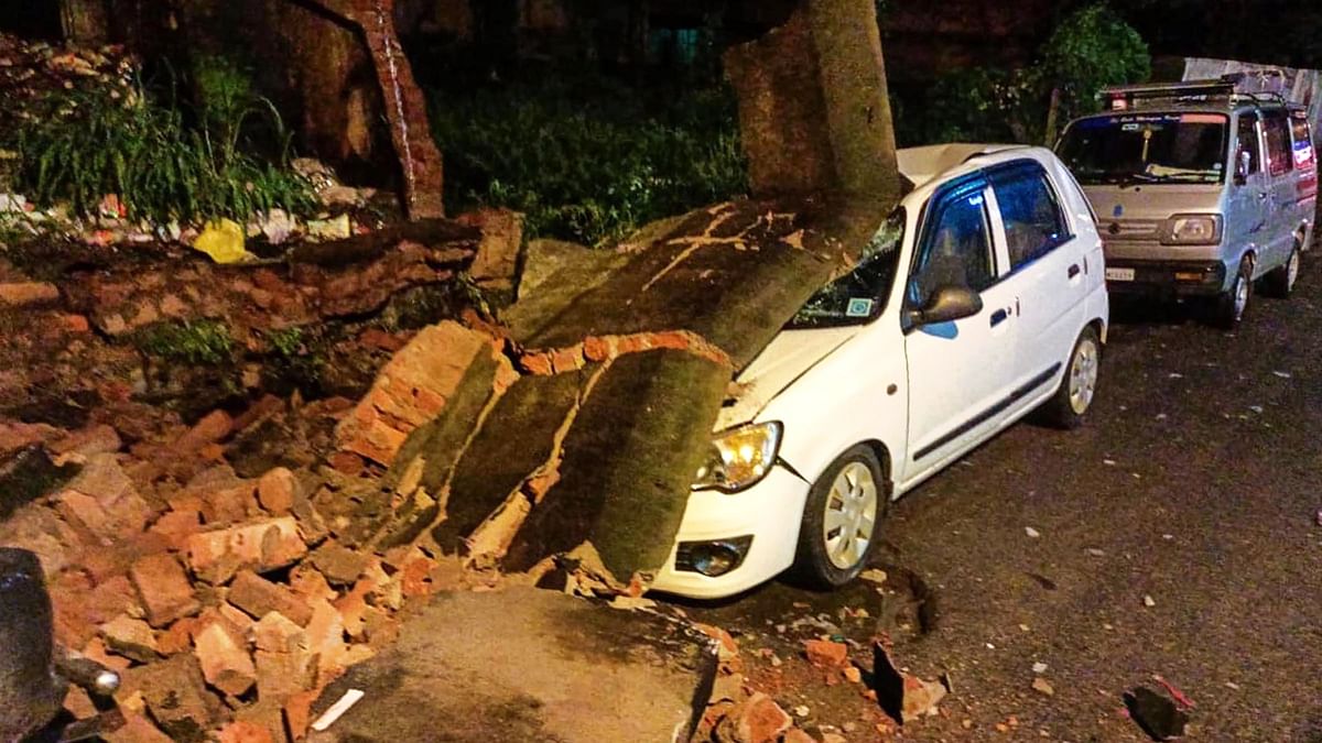 Chikmagalur: A car damaged under a compound wall that collapsed due to heavy monsoon rains. Credit: PTI Photo
