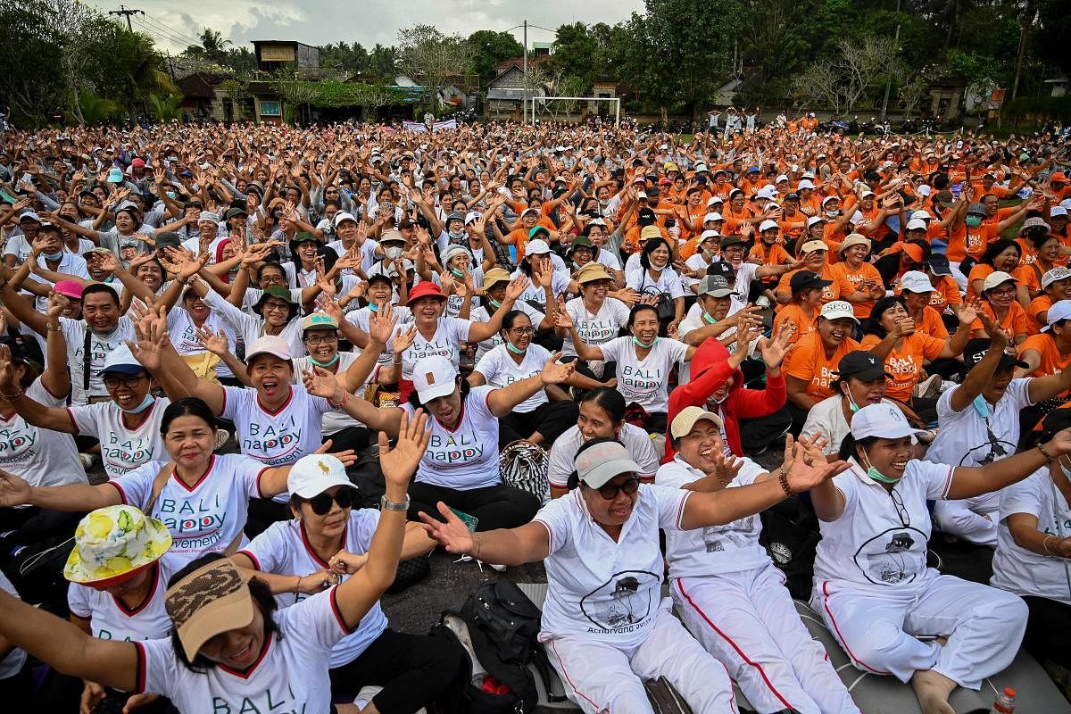 Balinese laugh together as 5000 Balinese people take part in a 'Laughing Yoga' event in Ubud on Indonesia Bali island. Credit: AFP Photo