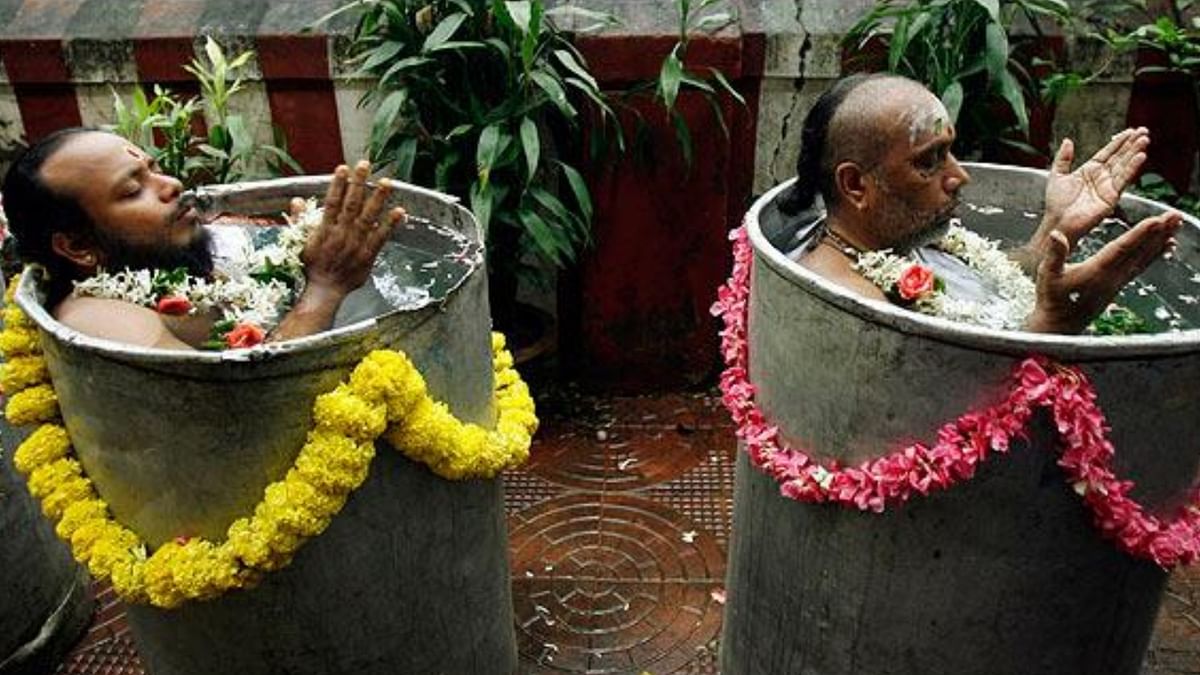 Varuna Yajna: Priests perform a special puja by immersing themselves in barrels of water and chanting the name of Lord Varuna 1,000 times as a prayer to bring rainfall. Credit: Reuters Photo
