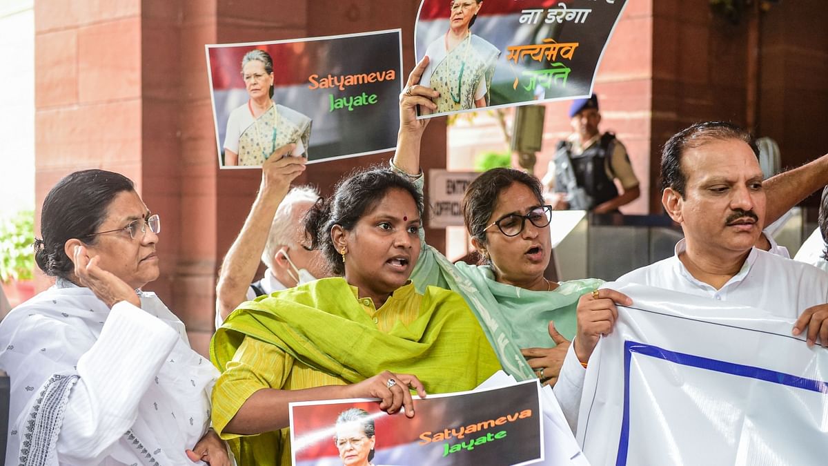 Congress MPs participate in a protest march at the Parliament House complex to express their solidarity with the party chief Sonia Gandhi. Credit: PTI Photo