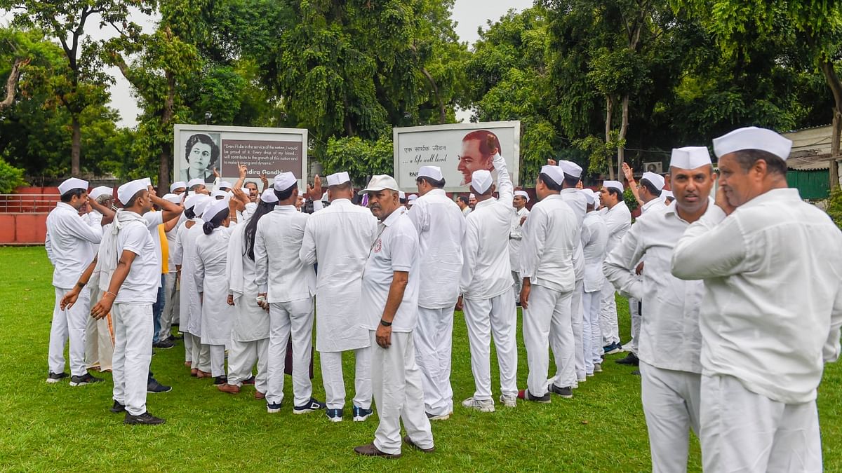 Congress Seva Dal members gather at the AICC headquarters to express their solidarity with the party President Sonia Gandhi, in New Delhi. Credit: PTI Photo