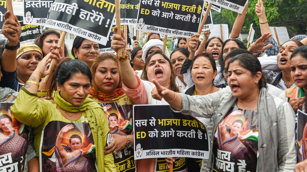 Congress Mahila Morcha members shout slogans as they gather at the AICC headquarters to express their solidarity with the party President Sonia Gandhi, in New Delhi. Credit: PTI Photo