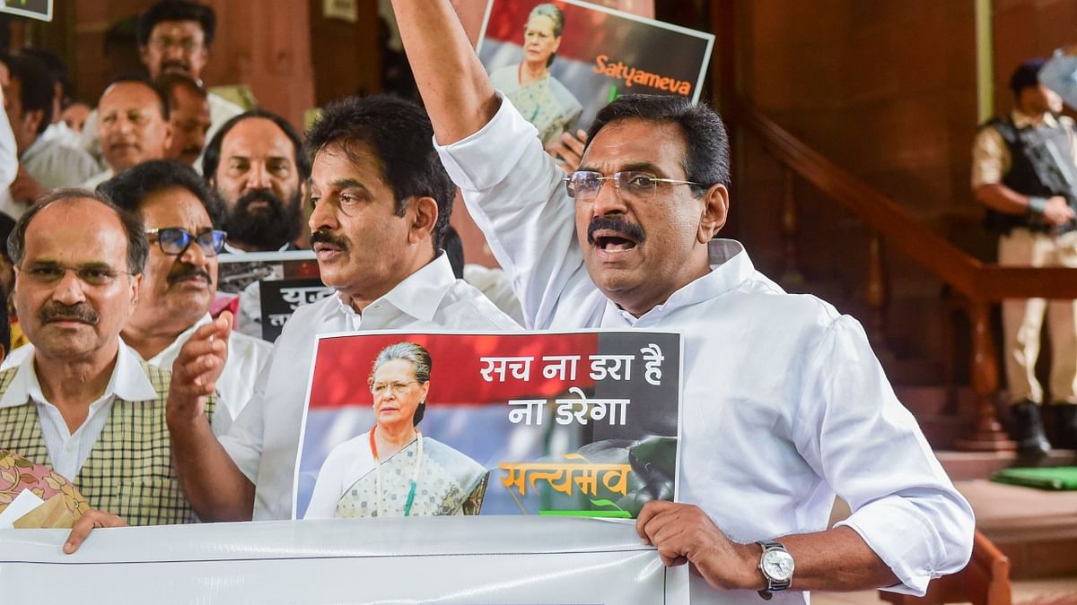 Congress MPs stage a protest march at Parliament House complex to express their solidarity with the party chief Sonia Gandhi, in New Delhi. Credit: PTI Photo