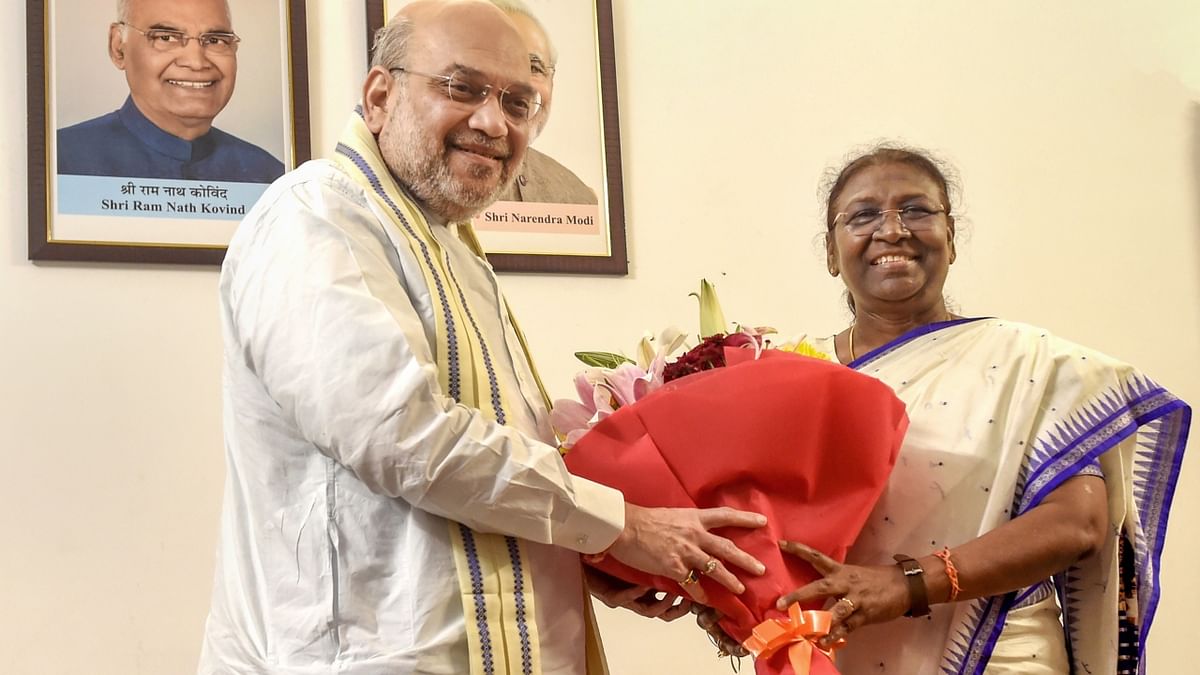 Union Home Minister Amit Shah felicitates president-elect Droupadi Murmu at her residence, in New Delhi. Credit: PTI Photo