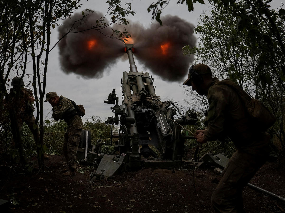 Ukrainian service members fire a shell from a M777 Howitzer at a front line, as Russia's attack on Ukraine continues, in Kharkiv Region, Ukraine. Credit: Reuters Photo