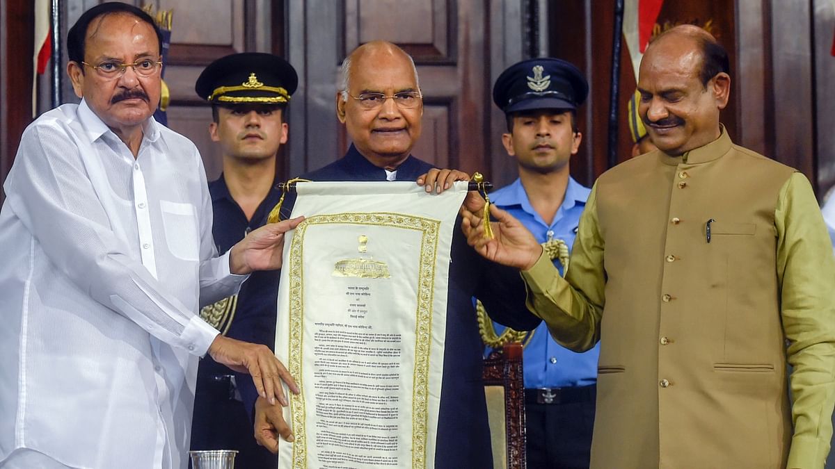 President Ram Nath Kovind being presented the 'Vidai Sandes' scroll by Vice President Venkaiah Naidu and Lok Sabha Speaker Om Birla during the farewell function at Parliament House in New Delhi. Credit: PTI Photo
