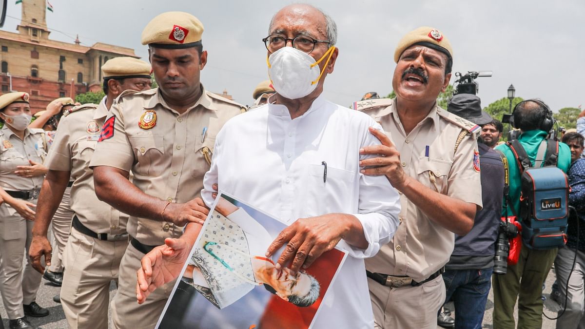 Police detain Congress MP Digvijay Singh during a protest march from Parliament to Rashtrapati Bhawan against ED's interrogation of the party's interim President Sonia Gandhi in the National Herald case, in New Delhi. Credit: PTI Photo