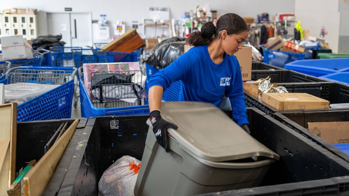 An employee sifts through bales of clothing at a Goodwill Outlet Center on July 27, 2022 in Hackensack, New Jersey. Credit: AFP Photo