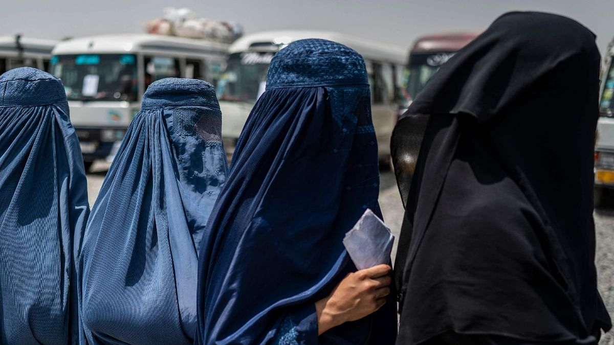 Afghan internally displaced refugee women stand in a queue to identify themselves and get cash as they return home to the east, at the United Nations High Commissioner for Refugees (UNHCR) camp in the outskirts of Kabul. Credit: AFP Photo