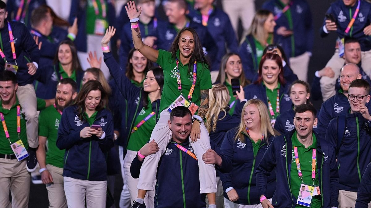 Northern Ireland boxer Carly McNaul is carried by a teammate in the athletes' Parade of Nations during the opening ceremony for the Commonwealth Games at the Alexander Stadium in Birmingham, central England. Credit: AFP Photo