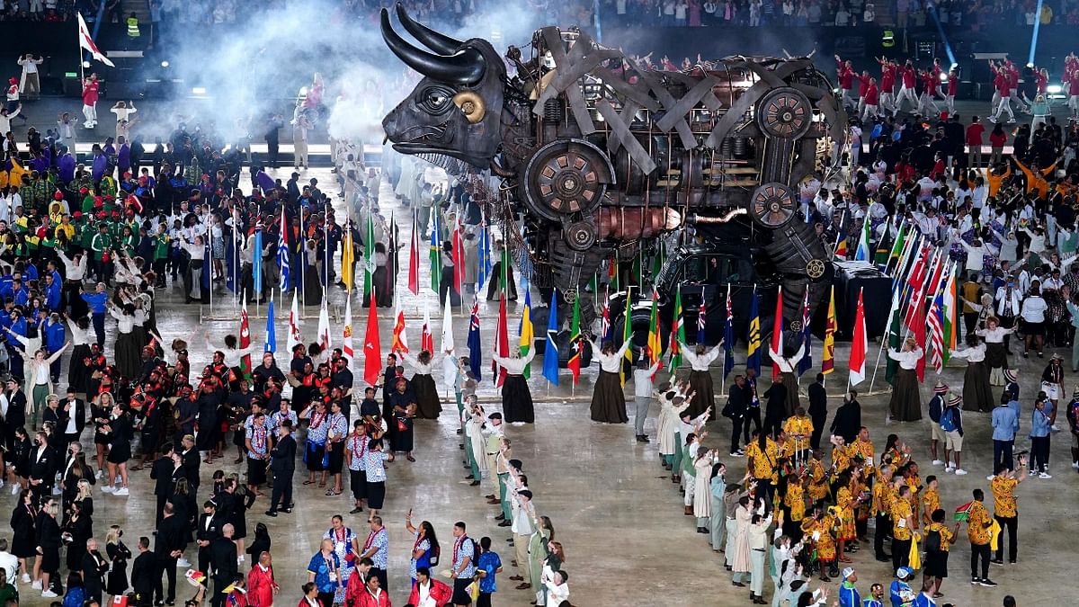 Athletes gather around the Raging Bull during the opening ceremony of the Commonwealth Games at the Alexander Stadium. Credit: AP Photo