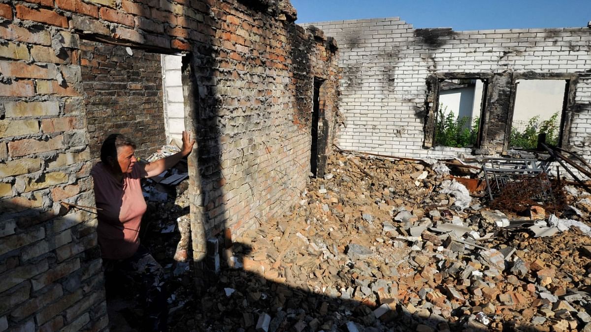 Olga, 67, looks at her house destroyed as a result of shelling in village of Moshchun, Kyiv region, on July 28, 2022, amid the Russian military invasion of Ukraine. Credit: AFP Photo