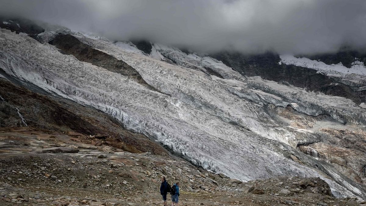 Tourists are seen next to the Fee Glacier (German: Feegletscher) above the Swiss alpine resort of Saas-Fee. Credit: AFP Photo