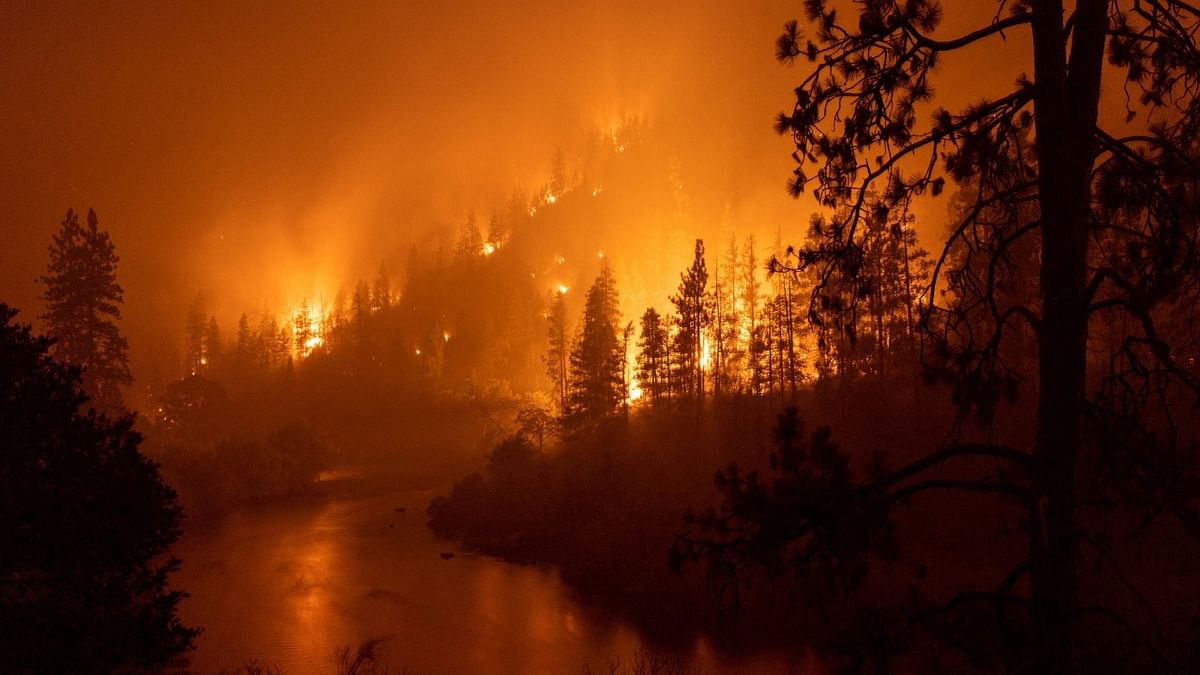 The largest fire in California this year is forcing thousands of people to evacuate as it destroys homes and rips through the state's dry terrain, whipped up by strong winds and lightning storms. The McKinney Fire was zero percent contained, CalFire said, spreading more than 51,000 acres near the city of Yreka. Credit: AFP Photo