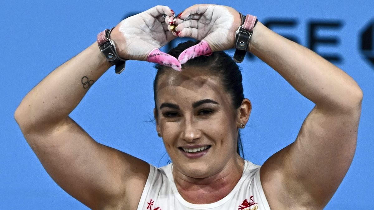 Sarah Davies gestures toward the photographers after securing the gold medal in the women's 71kg category weightlifting event, at the Commonwealth Games 2022 (CWG), in Birmingham. Credit: PTI Photo