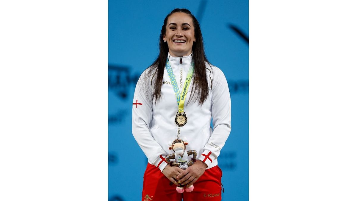 Gold medallist England's Sarah Davies celebrates on the podium after winning the women's 71kg final and setting a new Commonwealth Games record. Credit: Reuters Photo