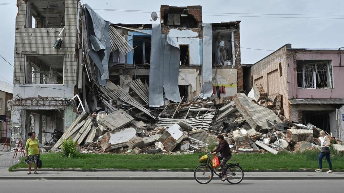 Pedestrians walk past a destroyed store in the city of Okhtyrka, Sumy region on August 1, 2022, amid the Russian invasion of Ukraine. - As towns and villages across Ukraine’s eastern countryside fell to the swift Russian invasion on February 24, Okhtyrka, a city of 48,000 on the Vorskla River, in Sumy region, resisted occupation. Credit: AFP Photo