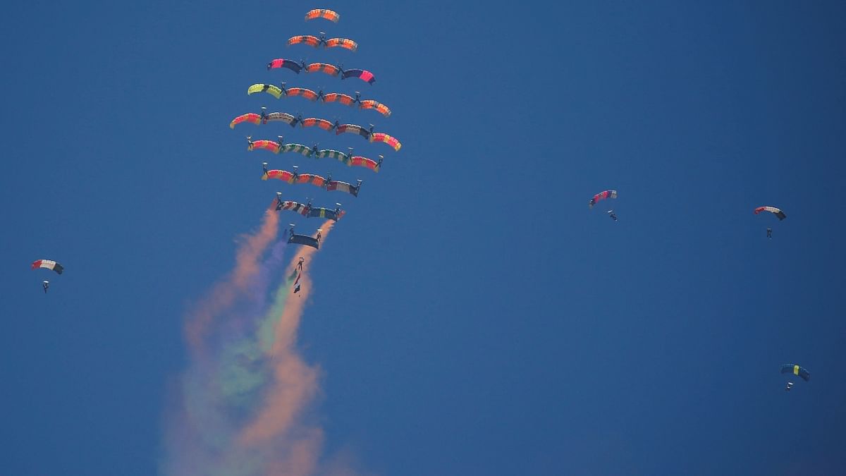 Aerobatic paratroopers perform stunts at the Pyramids Air Show 2022, at the Pyramids Plateau in Giza, Egypt. Credit: Reuters Photo