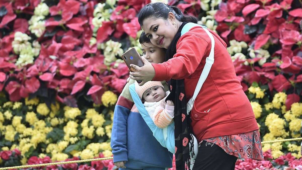 Visitors click selfies during their visit to the annual Independence Day flower show, at Lalbagh Botanical Garden in Bengaluru. Credit: PTI Photo