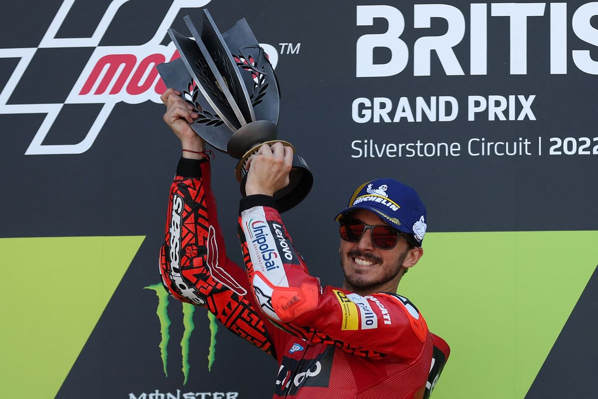 Ducati Lenovo's Italian rider Francesco Bagnaia holds the trophy during the podium ceremony as he celebrates his victory in the MotoGP race of the British Grand Prix at Silverstone circuit in Northamptonshire, central England. Credit: AFP Photo
